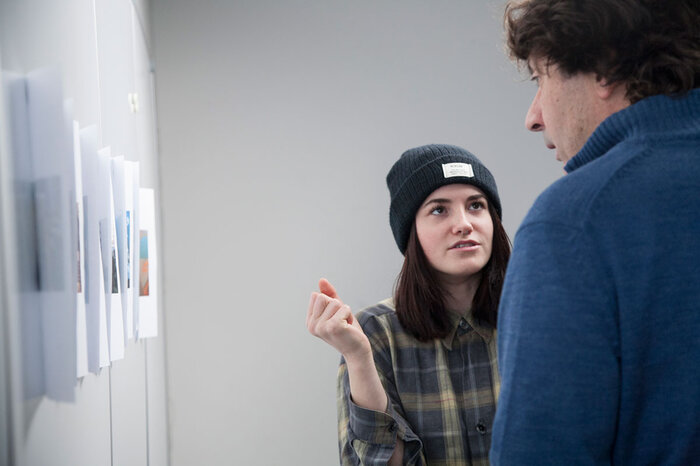 Photo workshop | © FHV Two students discuss photos on the wall. | © FHV