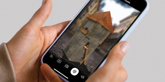 Design research project Ars Electronica 13 | © FHV Iphone in hand with augmented reality building on the screen | © FHV